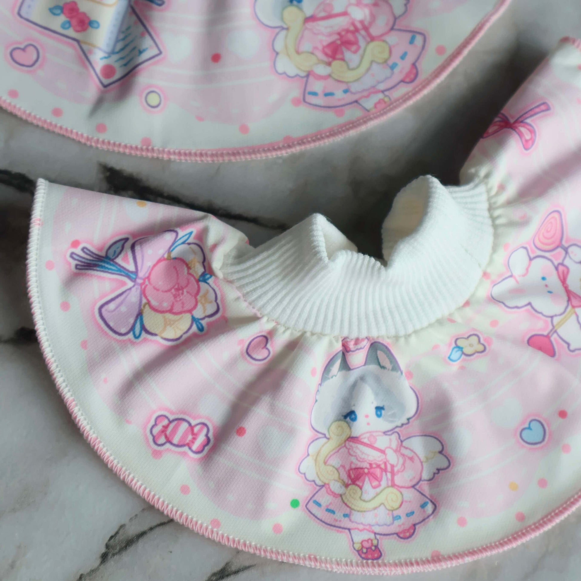 this shows a close up deatils of our valentines pet bib in pink.