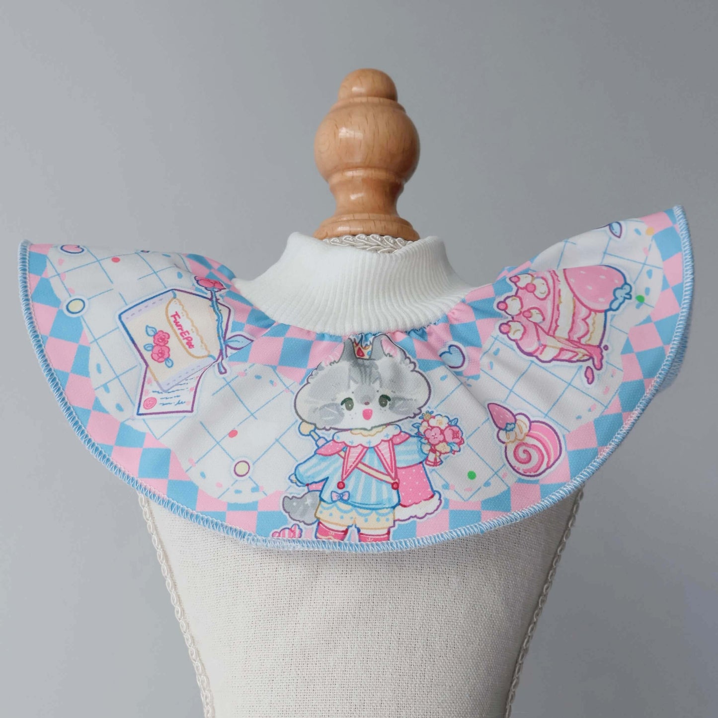 This photo showcases our size small valentine's pet bib in blue on the mannequin, recommended specifically for kittens and puppies.